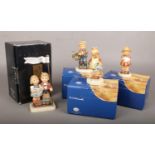 A boxed Hummel Club figure, Celebrate with Song, along with three other boxed Hummel Goebel figures.