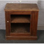 A low pine cabinet. Glass front missing.