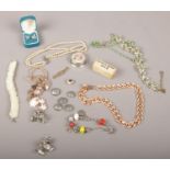 A collection of costume jewellery including charm bracelet, mother of pearl bracelet and crown and