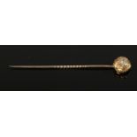 A Victorian gold stick pin set with 5 rose cut diamonds.