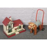 A vintage push along dog to include wooden doll's house