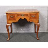 A walnut lowboy raised on cabriole legs.786