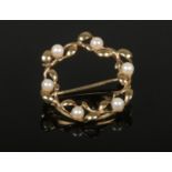 A 9ct gold and pearl wreath brooch, 2.8 grams gross.