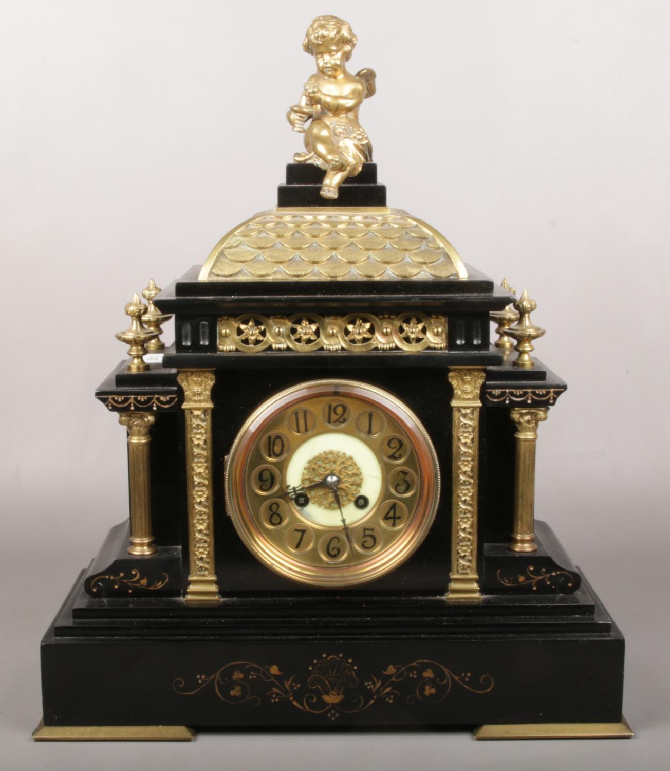 A Victorian slate and gilt metal mantel clock. Surmounted by a bacchanalian putti, with Classical