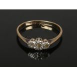 A 9ct gold and platinum three stone diamond ring. 1.3 grams gross, size M 1/2.