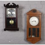 A carved oak wall clock, with silvered dial, along with a mahogany C Wood & Son wall clock.