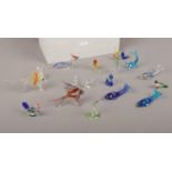 A box of glass animal figures, fish, dolphins, snakes etc