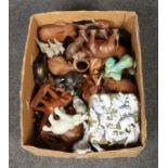 A box of elephant figures, to include ceramic and wooden examples.