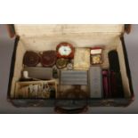 A suitcase of collectables to include military compass, pipes, cigarette cards, mother of pearl pill