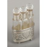 A trio of glass silver collared scent bottles in silver sleeve.