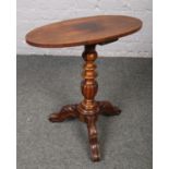 A Victorian rosewood and carved mahogany tripod wine table with oval top. Cracks and repair to