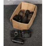 A box of camera equipment to include Zenit camera, Pentax camera, lenses etc.