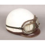 A 1950s leather motorcycle pudding basin helmet and goggles.