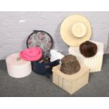 A collection of vintage hats and hat boxes
