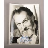 A signed monochrome photograph of actor Vincent Price.