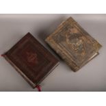 Two leather bound family bibles with colour plates. Cover badly damaged on one of the bibles.