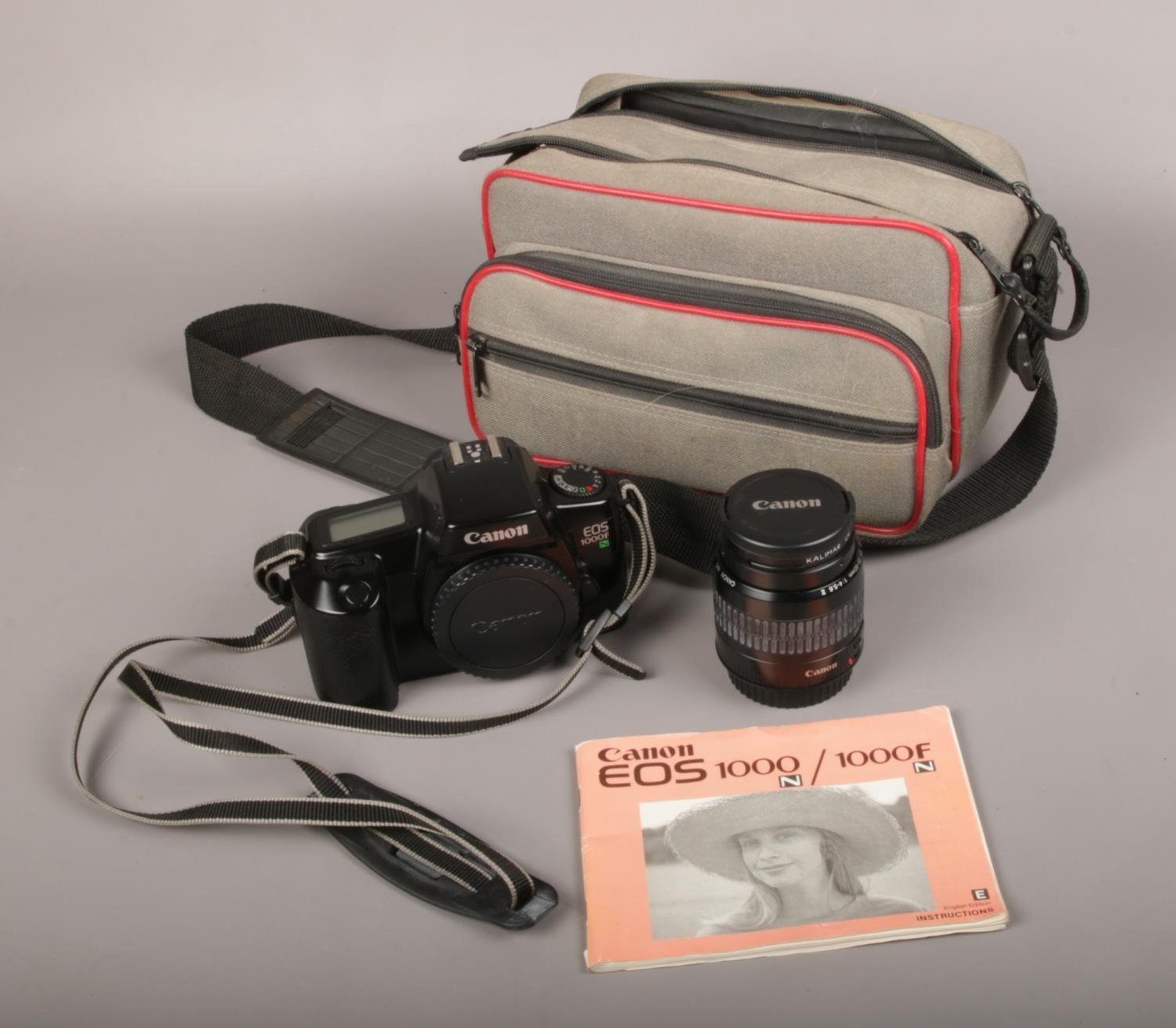 A Canon EOS 1000F 35mm SLR camera, along with a Canon EF 35mm-80mm lens and instruction manual.