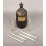 An Ammonia solution poison bottle along with four test tubes and two other glass bottles.