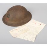A World War I U.S.A. MKI American Red Cross Brodie helmet. With label and original leather fittings.