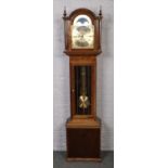 A mahogany Fenclocks long case clock with brass dial and sun and moon phase.