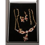 An Indian yellow metal suite of jewellery set with pink and white paste stones. Comprising necklet