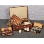 A vintage suitcase to include a collection of gentleman's sets in cases etc