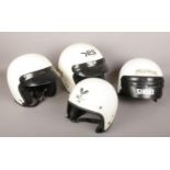 Four vintage open-faced motorcycle helmets including Centurion and Shoei.