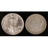 Two American silver dollars, 1903 and 1992.