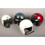Four vintage open-faced motorcycle helmets including Centurion.