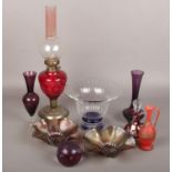 A group lot of glassware to include oil lamp, paperweight, coloured glass bowl etc.