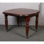 A Victorian mahogany wind-out dining table raised on fluted tapering supports, 104cm x 103cm. No