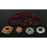 Three mid 20th century gilt metal turquoise and garnet effect brooches and a garnet effect necklace.