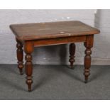 A Victorian walnut table raised on fluted supports, 68cm x 103cm. Formerly a wind-out dining table.