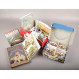 A mixed box to include postcards, War Titans, coins, Christmas decorations etc.