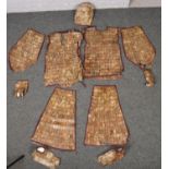 A Chinese Han Dynasty style jade coloured hardstone burial suit, the rectangular plaques joined by