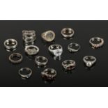 Fourteen silver dress rings including garnet and marcasite examples.