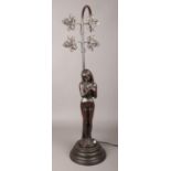 A bronzed composite figural table lamp base. (Height 70cm). Missing shade.