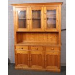 A pine kitchen dresser with glazed top section, 142cm wide, 198cm high, 40cm deep.