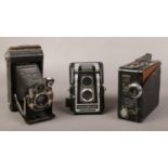 Three vintage cameras; Kodak bellows, Ross Ensign Fulvueflex and a Coronet model B9.5mm cine camera.