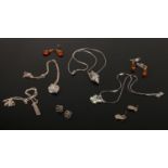 Four silver pendant necklaces and four pairs of silver earrings including amber examples.