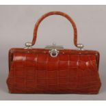 A ladies early 20th century leather and snakeskin evening bag. Fitted and with original