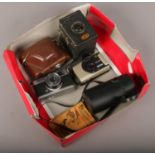 A box of camera equipment to include Ensign box camera, Olympus trip 35 camera, Komora lens etc.