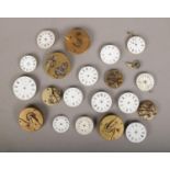 A tray of pocket watch movements, to include some with enamel dials.