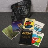 A bag of sheet music, Madness, Abba Gold, Simply Red examples