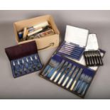 A box of cased and loose cutlery, to include souvenir spoons.