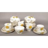 A Royal Albert part teaset decorated with yellow roses.