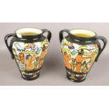 A pair of twin handle art pottery vases with Egyptian scene decorated. Large chip on the rim of