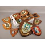 A small box of carved and painted wooden military shield plaques.