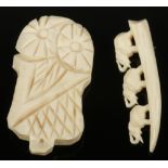 An African carved bone clip and similar carving.
