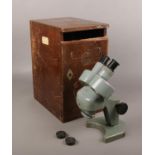 A cased Watson binocular microscope, model no. 134013.